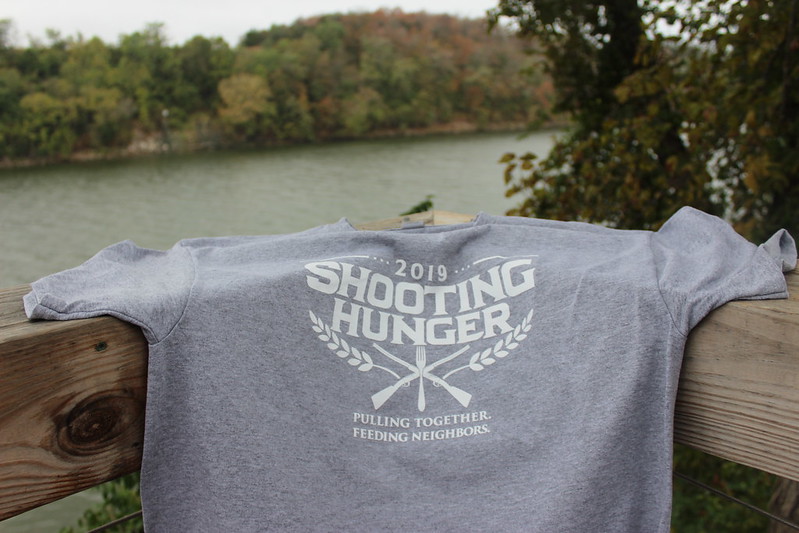Shooting Hunger t-shirt against a river backdrop